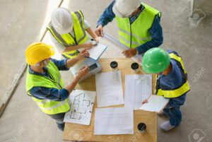 Construction team discussing project team performance around a table