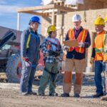 Construction team talking in a circle on the job site - project reboot
