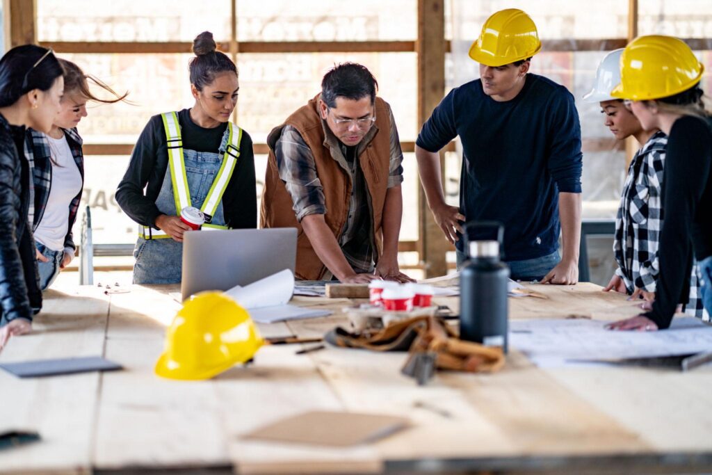 Construction team looking at blueprints on a table